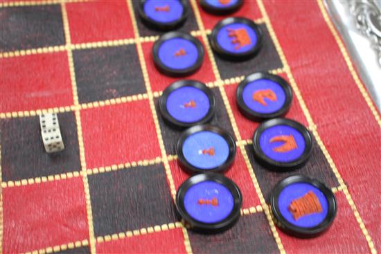 A 19th century Jaques Patent portable B.C.D. backgammon, chess and draughts board set, the gilt tooled red morocco cylinder holder